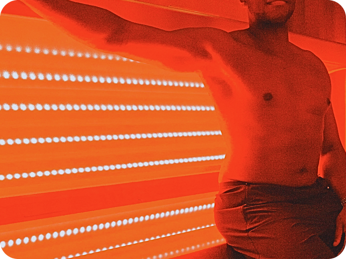 A client in the full-body red and near-infrared light bed