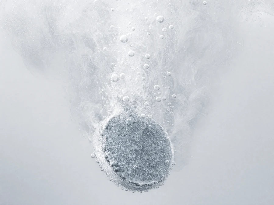 A Relief hydrogen bath tablet fizzing in water